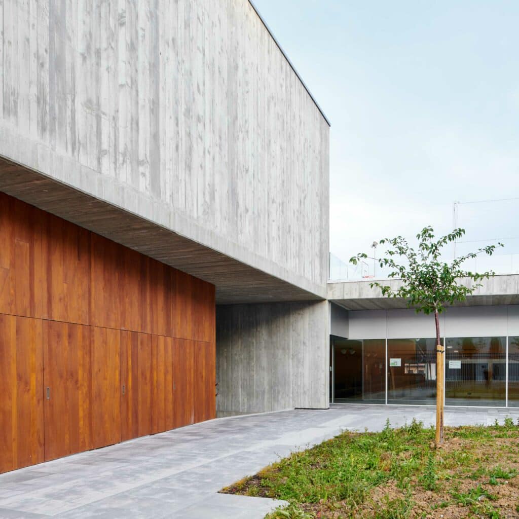 L'installation verticale des lames accentue le rythme visuel entre le béton et le bois.