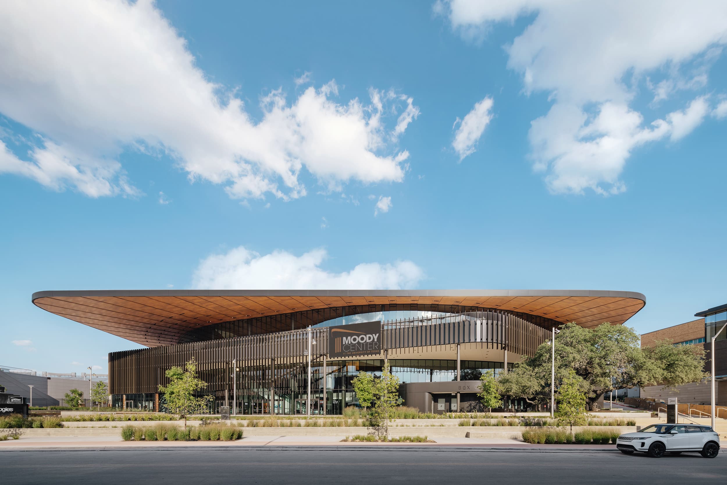 Parklex Prodema custom-installed natural timber soffit for a maintenance-free canopy at the University of Texas Moody Center Arena by GENSLER.